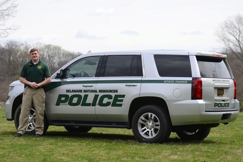 Brandon Pellegrini in front of Delaware Natural Resources Police vehicle