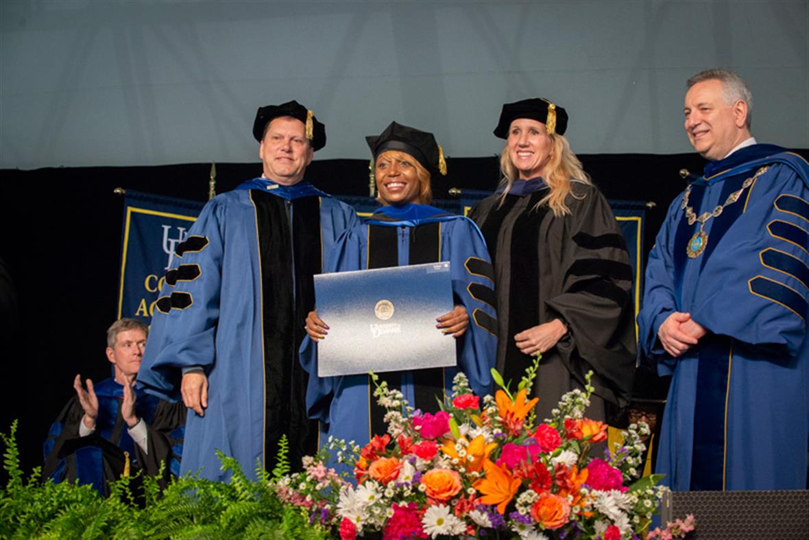 TaLisa J. Carter (second from left) was awarded her doctoral degree by College of Arts and Sciences Dean George Watson (left), Carter’s adviser, Prof. Karen Parker, and UD President Dennis Assanis at Friday’s Doctoral Hooding Convocation on The Green.